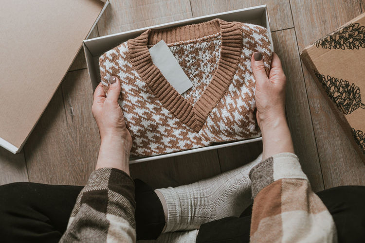 Midsection of woman holding gift