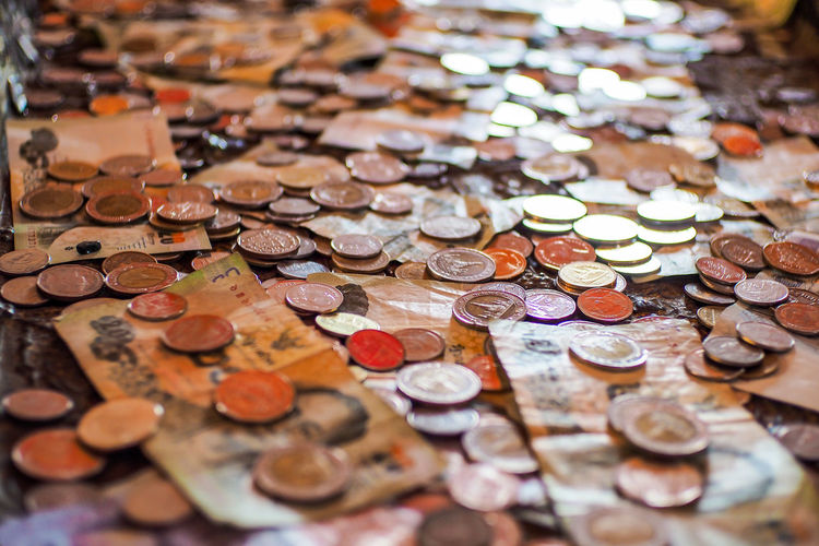 Full frame shot of paper currency and coins