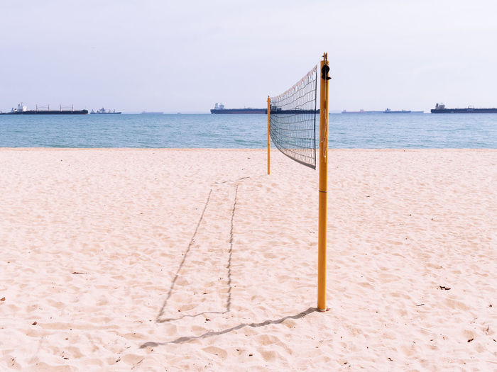 Empty volleyball court on sandy beach by the sea