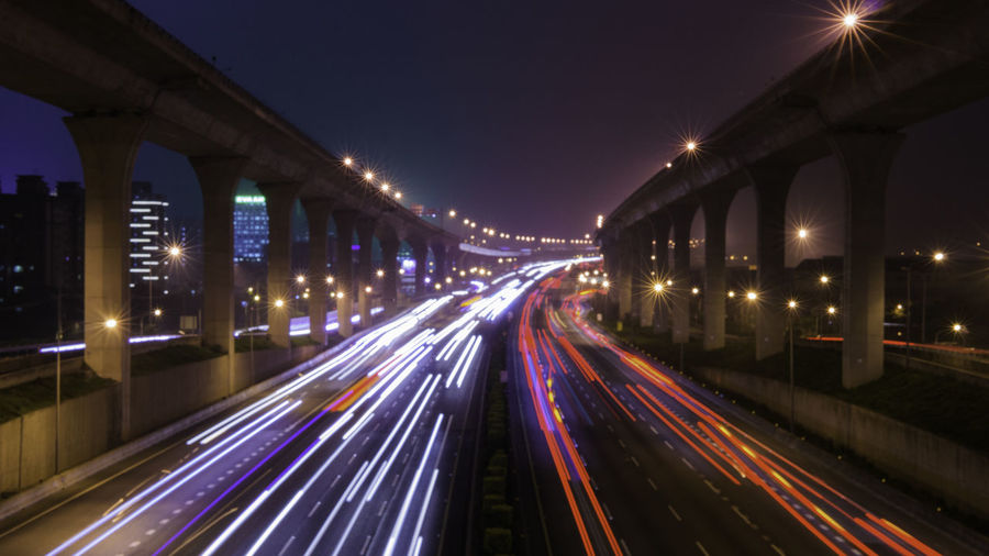 High angle view of light trails on multiple lane highway at night