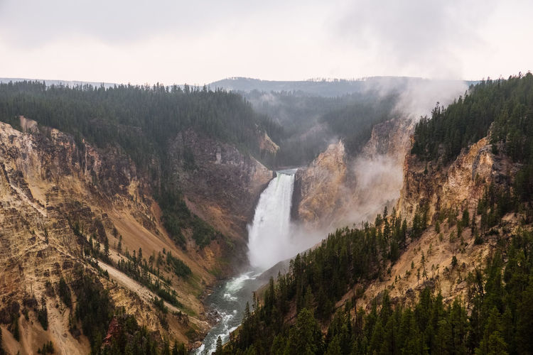 Scenic view of waterfall against sky