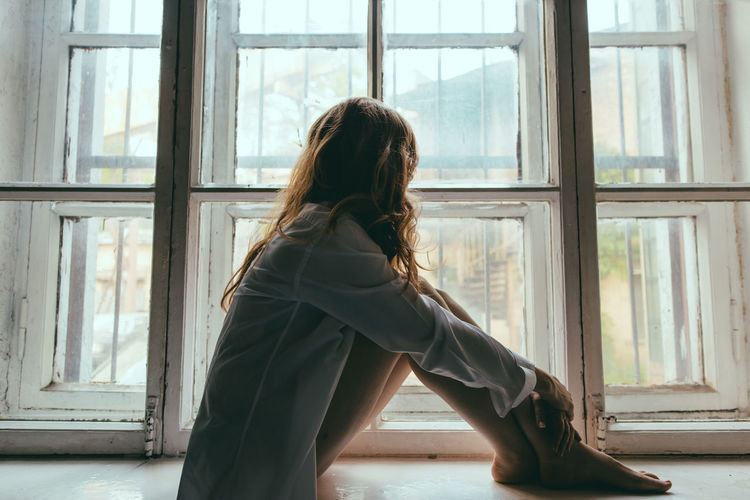 Adult Adults Only Curtain Day Indoors Long Hair Looking Through Window One Person One Woman Only One Young Woman Only Only Women People Rear View Sitting Window Women Young Adult Young Women Fresh On Market 2016