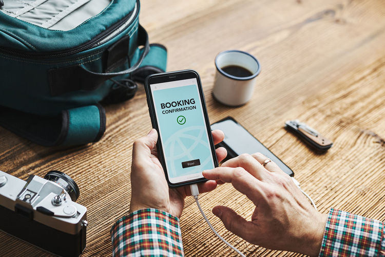 Man planning next vacation trip. booking hotel online using smartphone. paying for service. ordering