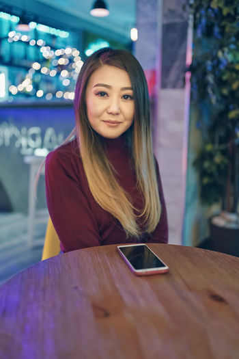 Portrait of a beautiful young woman in restaurant