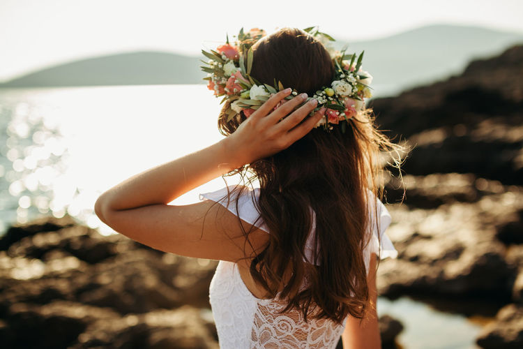 Woman wearing flowers at beach