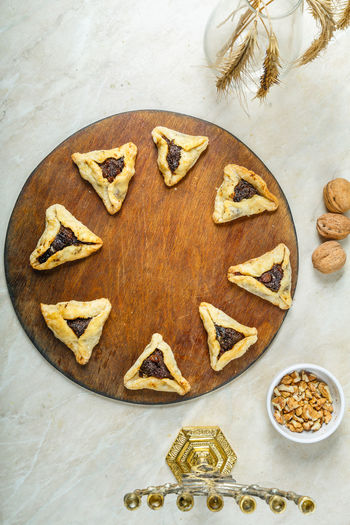 Gomentashi cookies traditional for the jewish holiday of purim on a round board on the table 