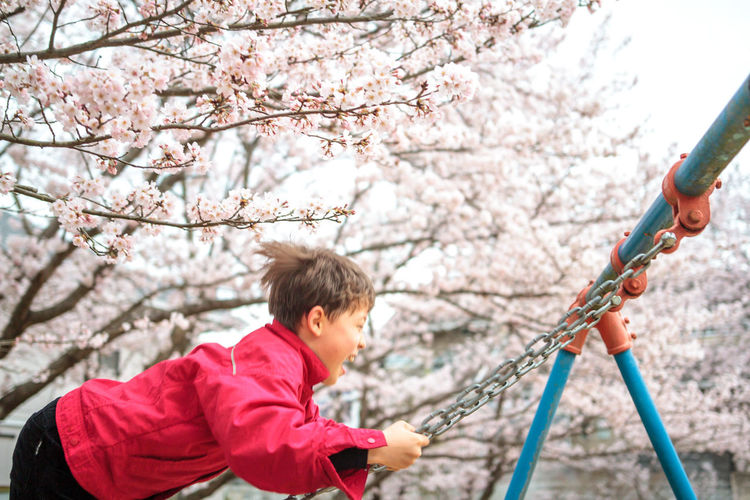 Woman holding flower in park