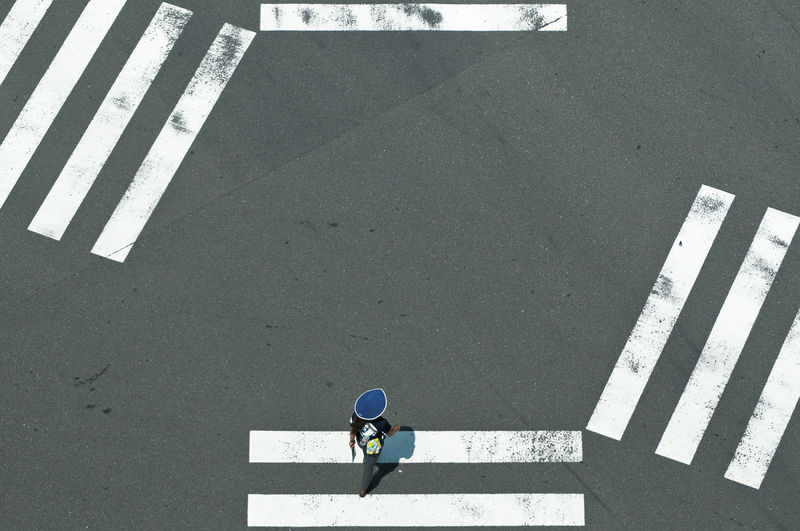 High angle view of man crossing road