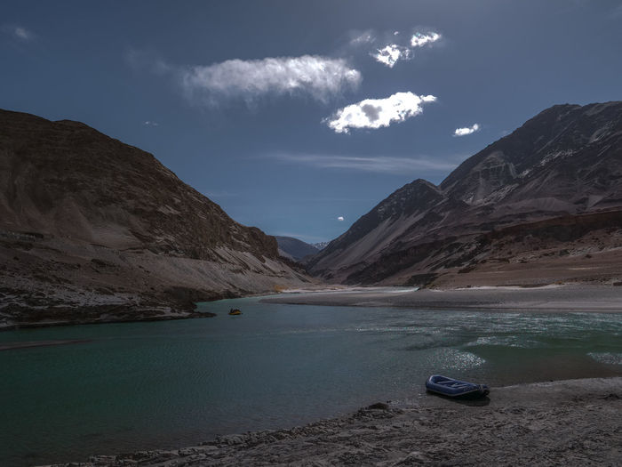Scenic view of lake and mountains against sky