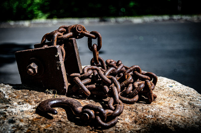 Close-up of padlocks on rusty chain
