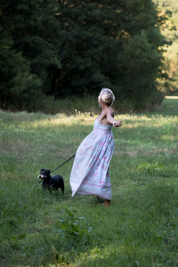 Woman with dog on field