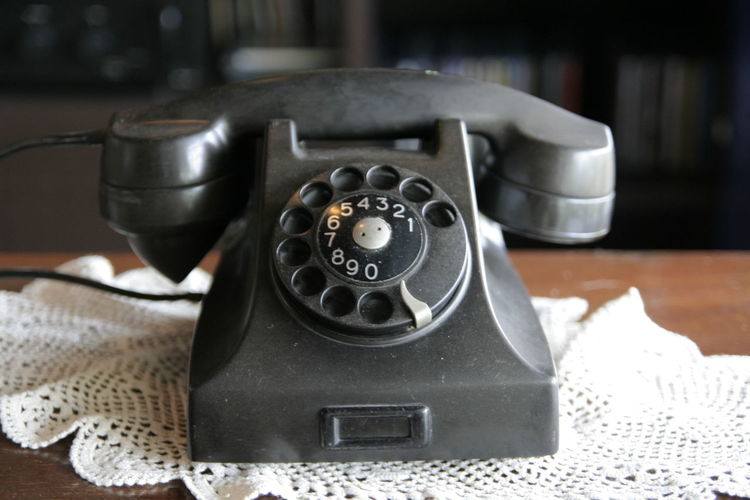 Close-up of old telephone on table