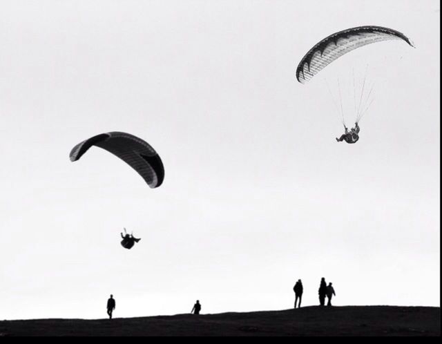 leisure activity, real people, extreme sports, parachute, silhouette, mid-air, adventure, paragliding, flying, sport, lifestyles, outdoors, day, men, full length, sky, nature, people, adult