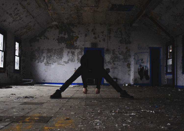 Rear view of person standing in abandoned building