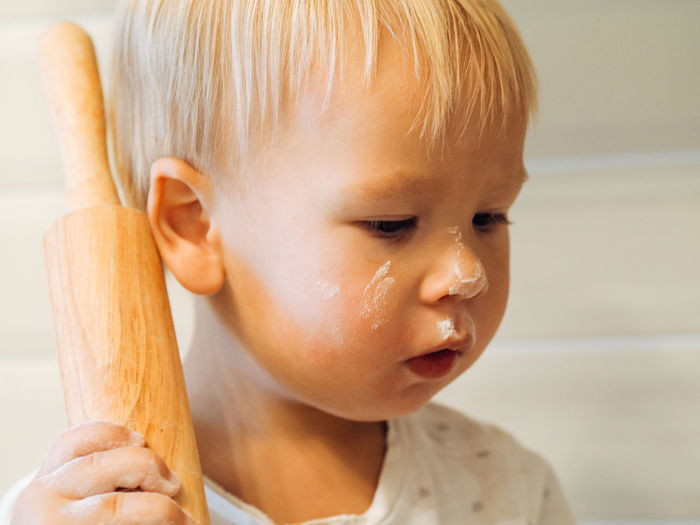Cute boy holding rolling pin
