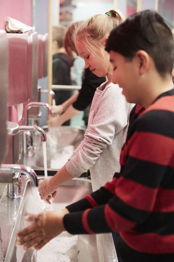 Junior high students washing hands in school
