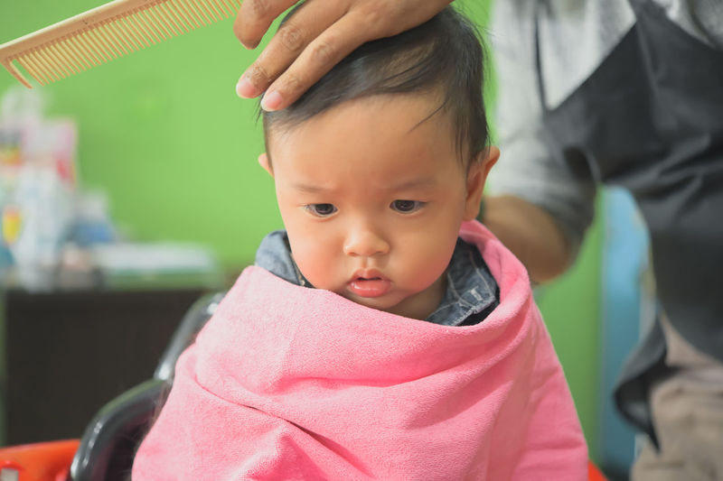 Portrait of cute baby girl looking away