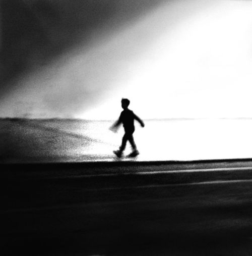 Side view of silhouette man walking against sky