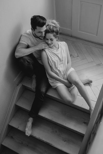 High angle view of couple sitting on floor at home