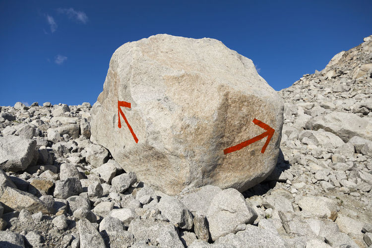Arrows on boulder point way for hikers, talkeetna mountains, alaska