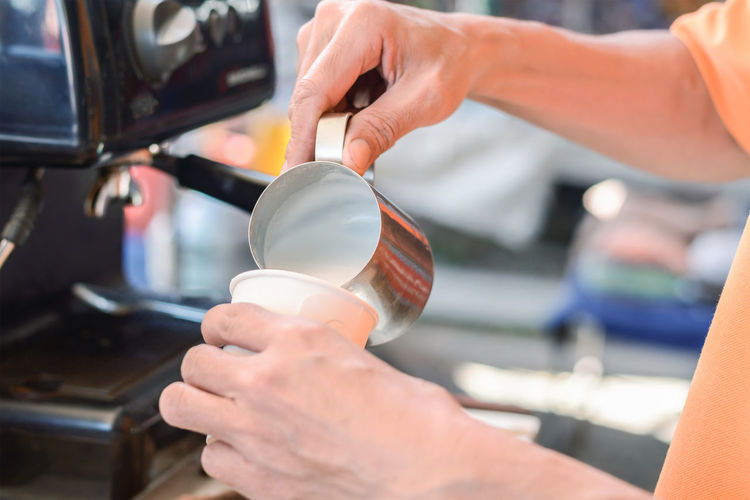 Cropped image of person preparing coffee