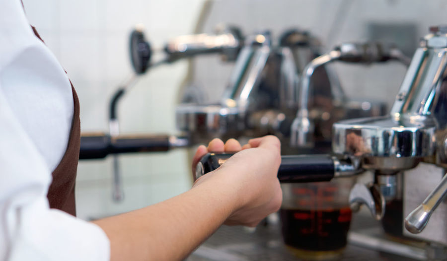 Cropped image of man having coffee at cafe