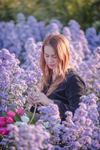 Beautiful woman in flowering plants