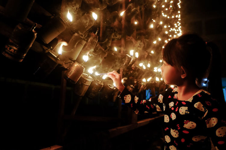Rear view of woman looking at illuminated christmas lights