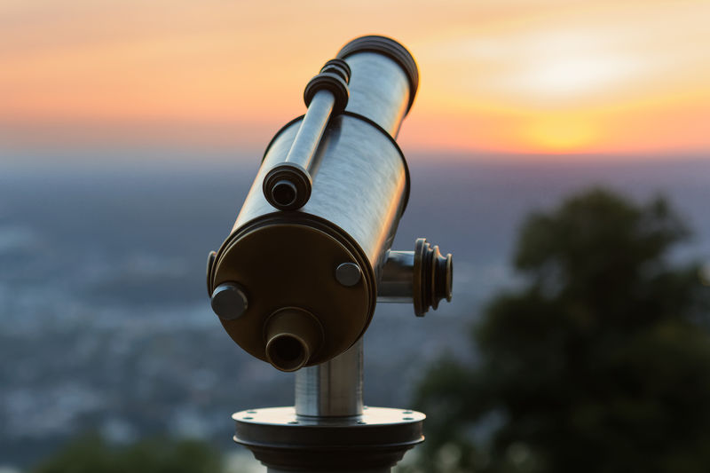 Close-up of coin-operated telescope against sky during sunset at famous petersberg