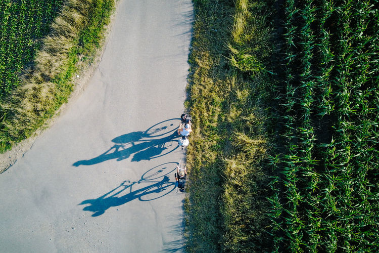 High angle view of people riding bicycle on road