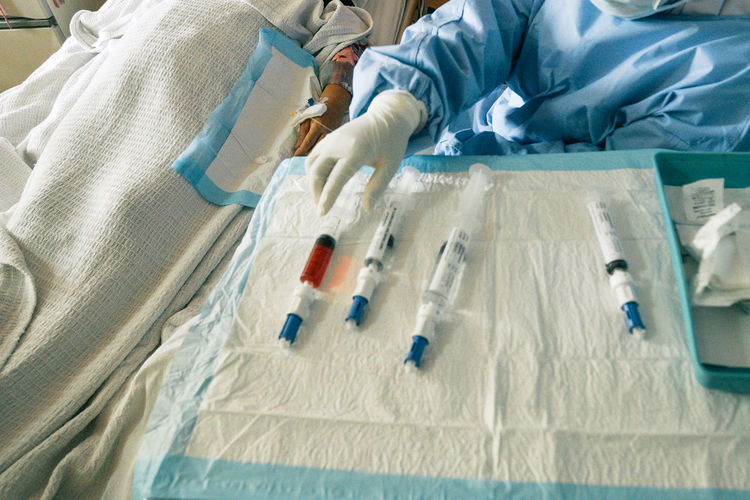 High angle view of medical syringes on white cloth in a hospital