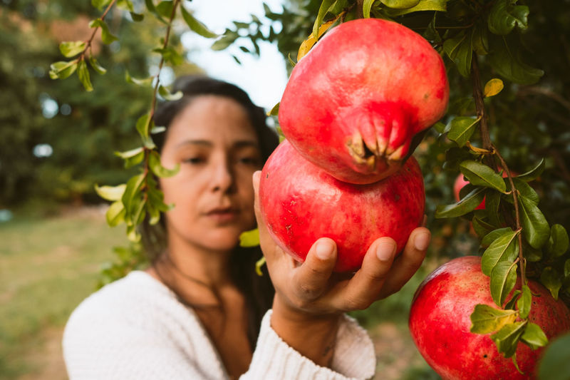 Full length of woman holding apple