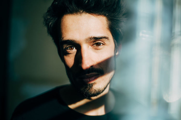 portrait of dark-haired man with shadow Portraits Positive Shadows & Lights Adult Beard Close-up Facial Hair Focus On Foreground Front View Headshot Human Face Indoors Looking At Camera Males Mid Adult Mid Adult Men Mustache One Person Portrait Real People Smile Young Adult Young Men The Portraitist - 2018 EyeEm Awards