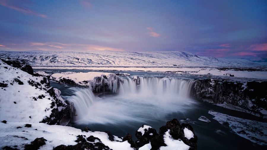 Scenic view of waterfall at night during winter