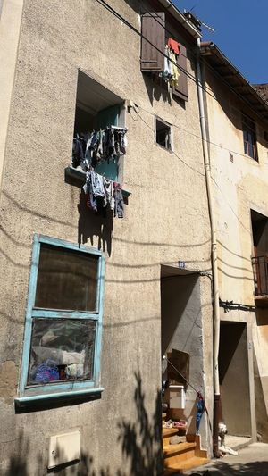 Low angle view of clothes drying on building