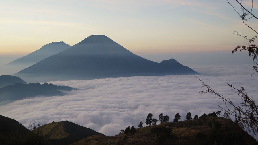 Scenic view of mountains against cloudy sky