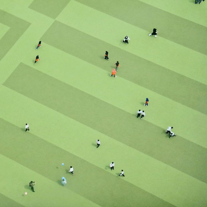 High angle view of students playing at schoolyard
