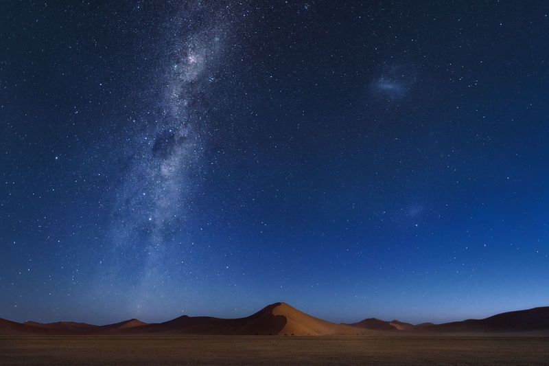 Scenic view of mountain against star field at night