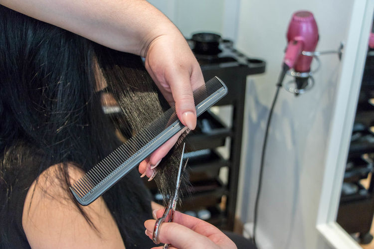Female customer having haircut at salon