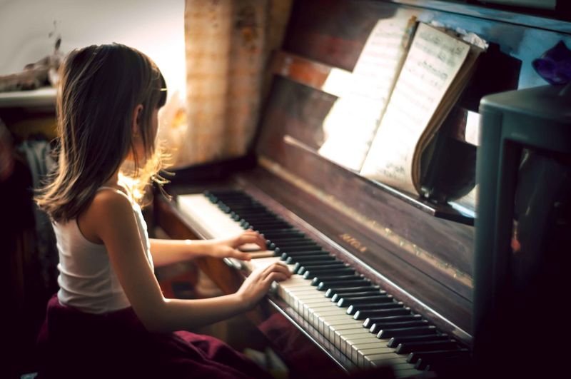 Girl playing piano at home