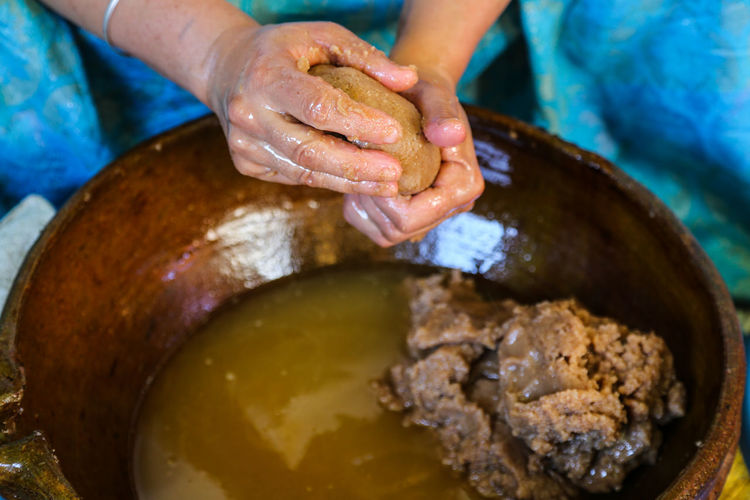 Cropped hand of woman preparing argan oil