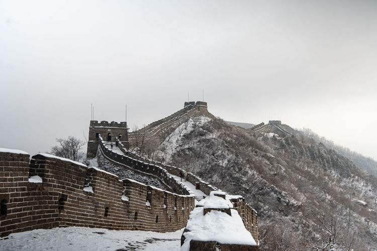 Stunning view of great wall of china covered with snow during a winter day
