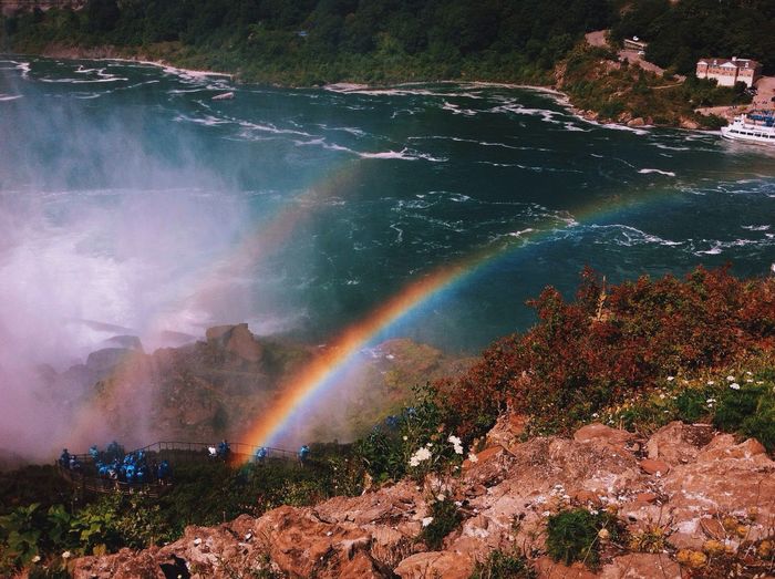 High angle view of rainbow on mountain by river