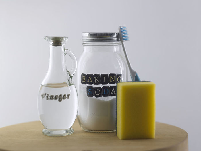Vinegar and baking soda on the white background