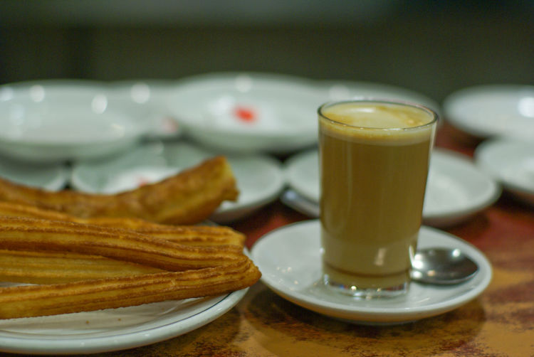 Coffee and churros served on a table