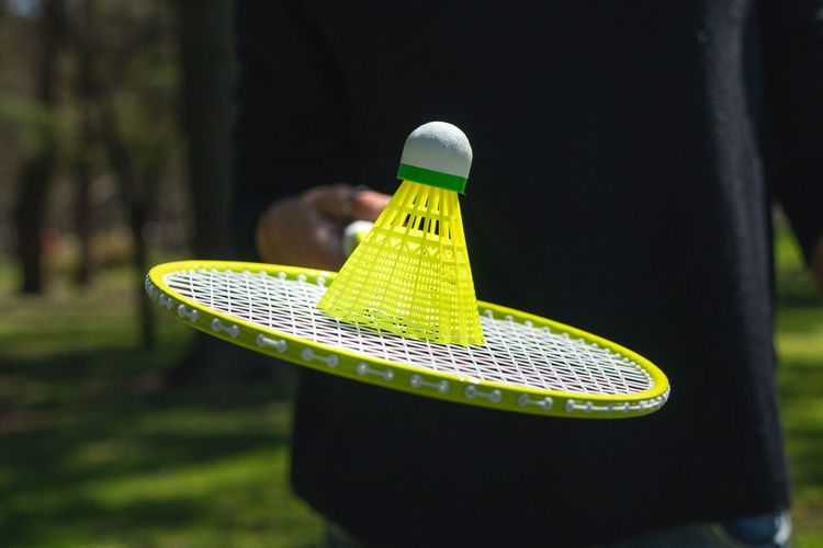 Close-up of yellow holding ball in park