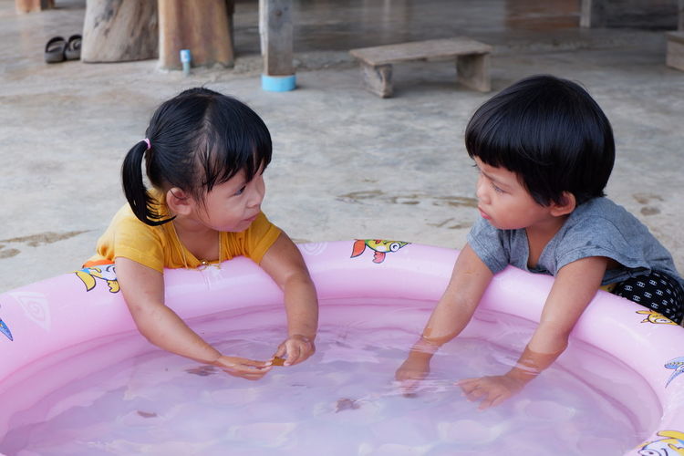 Cute sisters with wading pool