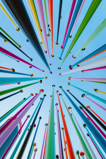 Bottom view of artistic construction made from colored poles in citylife park in milan