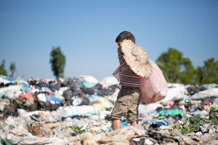 Poor children collect garbage for sale because of poverty, junk recycle, child labor.