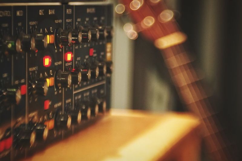 Close-up of illuminated synthesizer in recording studio
